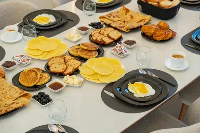 a table topped with plates of food and desserts at Luxury Villa Heated Pool, Cinema & Game Room in Marrakech