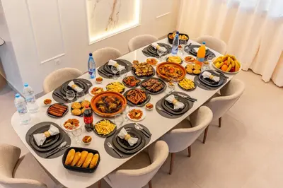 a table with plates of food on it at Luxury Villa Heated Pool, Cinema & Game Room in Marrakech