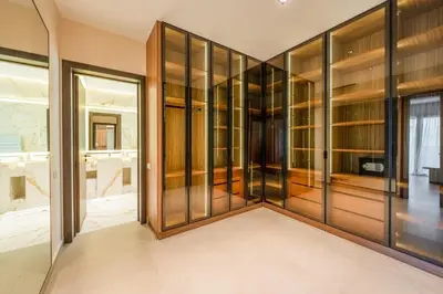 a large glass walk in closet with wooden shelves at Luxury Villa Heated Pool, Cinema & Game Room in Marrakech