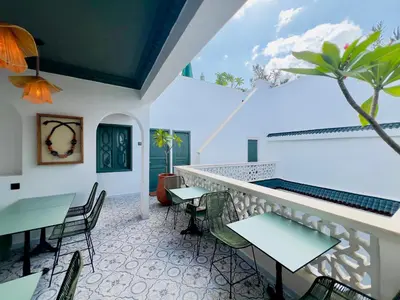 a balcony of a restaurant with tables and chairs at Riad Kaya in Marrakech