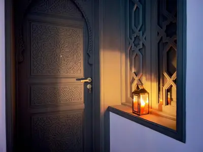 a lantern sitting next to a door with a mirror at Riad Kaya in Marrakech