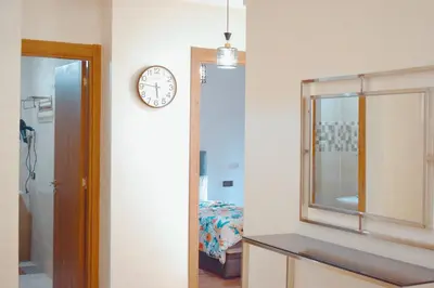 a bathroom with a mirror and a clock on the wall at Appartement Marrakech in Marrakech