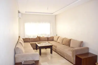 a living room with a couch and a table at Appartement Marrakech in Marrakech