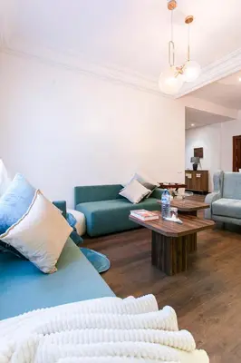 a living room with two blue couches and a coffee table at Prestige Zone Marrakech in Marrakech