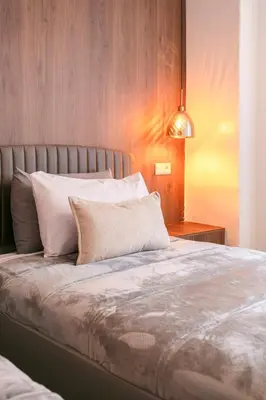 a bed with white pillows and a lamp in a bedroom at Prestige Zone Marrakech in Marrakech