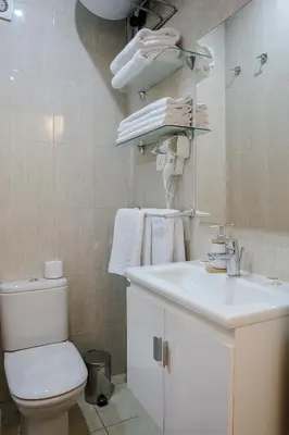 a bathroom with a white toilet and a sink at Prestige Zone Marrakech in Marrakech