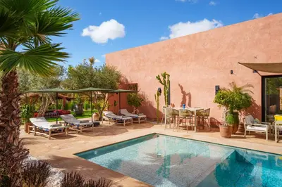 a swimming pool in a yard with chairs and a table at Villa Nomade - 4 BR BA - Piscine - Parking - Ourika in Sraghna