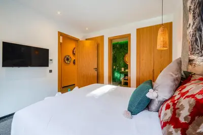 a bedroom with a white bed with a teddy bear on it at Villa Nomade - 4 BR BA - Piscine - Parking - Ourika in Sraghna