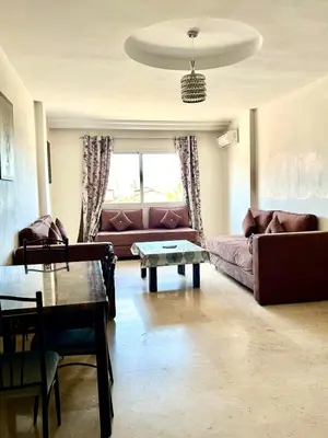 a living room with a couch and a table at imm O Family apartment 7 in Marrakech