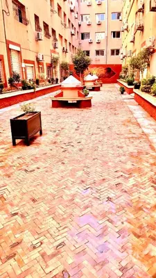a courtyard with benches and tables in a building at imm O Family apartment 7 in Marrakech
