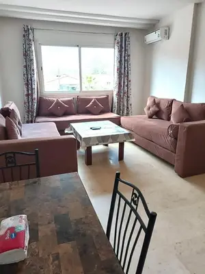 a living room with a couch and a table at imm O Family apartment 7 in Marrakech