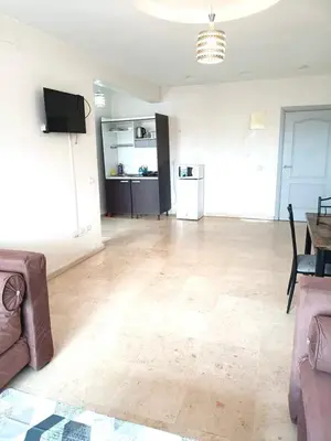 a living room with a couch and a table at imm O Family apartment 7 in Marrakech