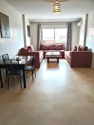 a living room with a couch and a table at imm O Family apartment 7 in Marrakech