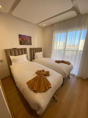 a bedroom with two beds with a tray on it at Cozy apartment with pool Bd Mohamed 6 in Marrakech