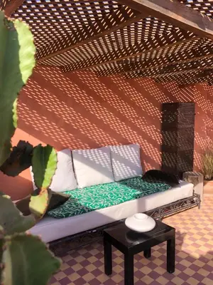 a couch sitting in a room with a table at SAMA DABACHI Vibrant Medina Loft and Roof top in Marrakech