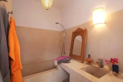 a bathroom with a tub and a sink and a mirror at SAMA DABACHI Vibrant Medina Loft and Roof top in Marrakech