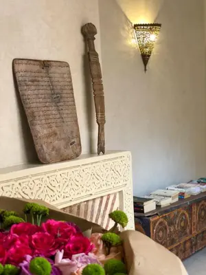 a box filled with pink flowers next to a wall at SAMA DABACHI Vibrant Medina Loft and Roof top in Marrakech