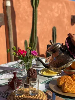 a table with a tea pot and flowers on it at SAMA DABACHI Vibrant Medina Loft and Roof top in Marrakech
