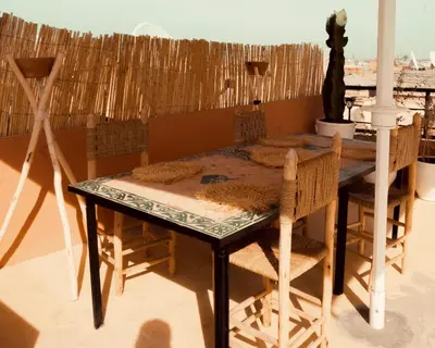 a dining room table with chairs and a tableablish at Savor Home Authentic Entire Riad with Medina View & Terrace in Marrakech