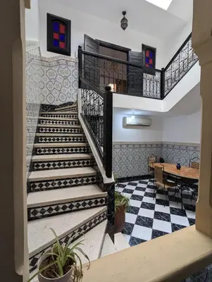 a staircase in a house with a checkered floor at Almohafidon room in Marrakech
