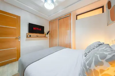 a bedroom with a bed and a wooden door at Comfort and Serenity in the Center of Marrakech in Marrakech