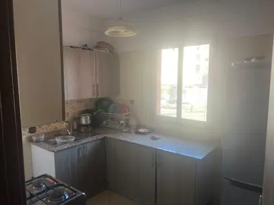 a kitchen with a counter and a window in it at Aéroport Menara marrakech in Marrakech