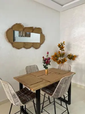 a dining room with a wooden table and chairs at Home Star Luxury Apartment Marrakech in Marrakech