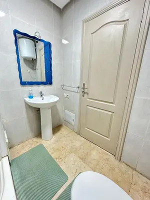 a bathroom with a white toilet and a sink at apartment 9 imm O in Marrakech