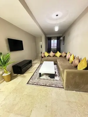 a living room with a couch and a table at apartment 9 imm O in Marrakech
