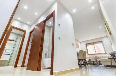 a room with a bathroom with a toilet and a mirror at Marrakech Haven Appartement Familial Wifi HD IPTV Netflix in Marrakech