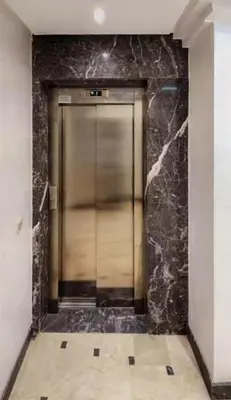 a elevator in a building with a marble wall at Marrakech Haven Appartement Familial Wifi HD IPTV Netflix in Marrakech