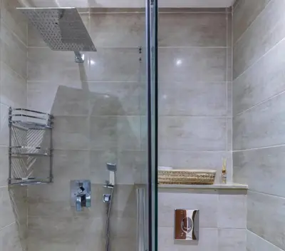 a shower with a glass door in a bathroom at Marrakech Haven Appartement Familial Wifi HD IPTV Netflix in Marrakech