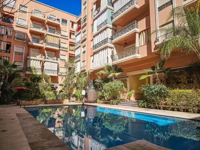 a swimming pool in front of a building at Oasis - 7 min from Majorelle - Medina and Nightlife with AC and Pool in Marrakech
