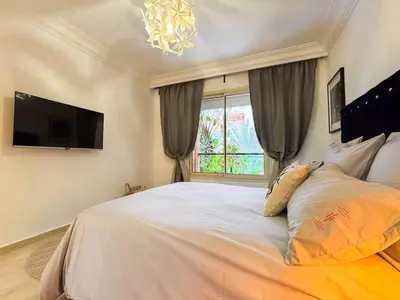a bedroom with a large bed and a window at Oasis - 7 min from Majorelle - Medina and Nightlife with AC and Pool in Marrakech