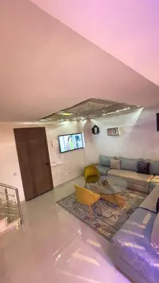 a living room with a couch and a table at Duplex Luxury Appartement in Marrakech