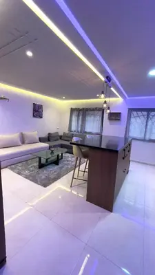 a living room with a couch and a table at Duplex Luxury Appartement in Marrakech