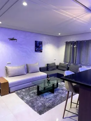 a living room with a couch and a table at Duplex Luxury Appartement in Marrakech
