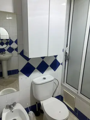 a bathroom with a toilet and a sink at Bel appartement au relaxer in Marrakech