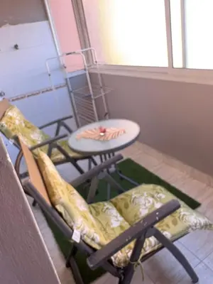 a room with two chairs and a table and a chair at Bel appartement au relaxer in Marrakech