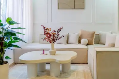 a living room with a table and a couch at Downtown Gueliz Modern 1BR AC, Fast WIFI , Parking in Marrakech