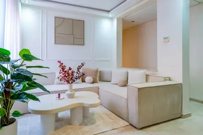 a living room with a white couch and a table at Downtown Gueliz Modern 1BR AC, Fast WIFI , Parking in Marrakech