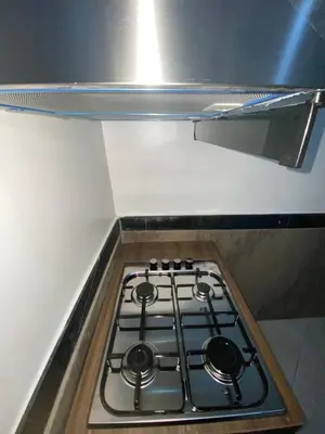 a stove top in a kitchen with a counter top at Appartement bros in Marrakech