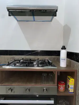 a stove top oven sitting in a kitchen at Appartement bros in Marrakech