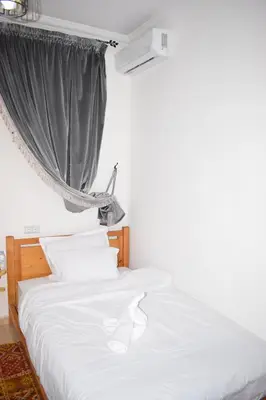 a bedroom with a white bed with a window at Maison Marrakech in Touggana