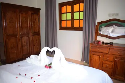 two swans making a heart shape on a bed at Maison Marrakech in Touggana