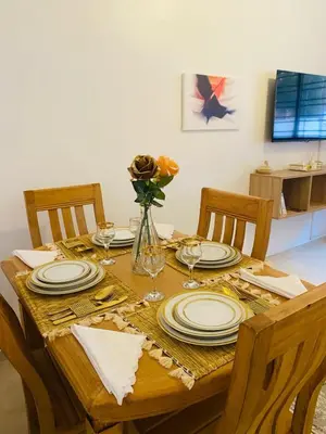 a wooden table with plates and a vase of flowers at Dar sultane in Marrakech