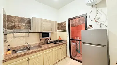 a kitchen with a sink and a refrigerator at Dar sultane in Marrakech