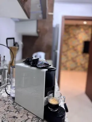a toaster sitting on a counter with a cup of coffee at The Cristal House in Marrakech