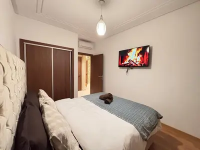 a bedroom with a teddy bear sitting on a bed at The Cristal House in Marrakech