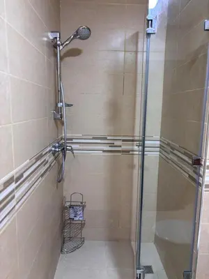 a shower with a glass door in a bathroom at The Cristal House in Marrakech